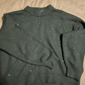Black sweater. High low affect on the back. Fits more like a small